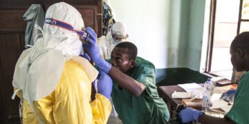 Healthcare workers treat a patient during an infectious disease response in the Democratic Republic of Congo