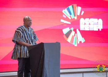 Ghana President John Dramani Mahama speaking at a podium while presenting the Accra Reset agenda at an international forum.