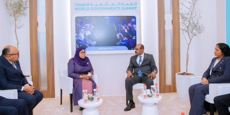 President Samia Suluhu Hassan seated in a formal lounge setting at the World Governments Summit in Dubai, holding bilateral talks with Antigua and Barbuda Prime Minister Gaston Browne while officials sit nearby