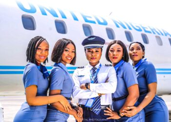 United Nigeria Airlines cabin crew and pilot standing beside aircraft as airline announces global expansion and new international routes