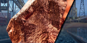 Copper ore sample with mining conveyors and rail infrastructure in an African mine setting.