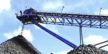 Conveyor belt discharging ore onto a rock stockpile at a large-scale platinum mine near Darwendale, Zimbabwe