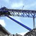 Conveyor belt discharging ore onto a rock stockpile at a large-scale platinum mine near Darwendale, Zimbabwe