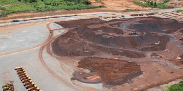 Aerial view of large-scale open-pit mining operation in Africa showing haul trucks and mineral stockpiles supporting critical minerals production