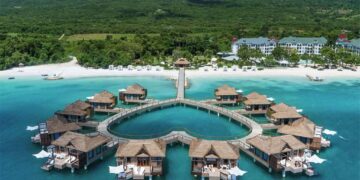 Aerial view of luxury overwater villas along Jamaica’s tropical coastline showcasing premium Caribbean tourism and resort experiences