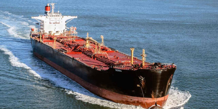 'A large black and red crude oil tanker moving through open water, leaving a white wake behind it