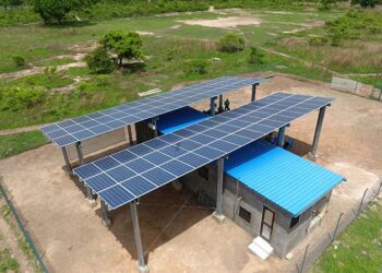 Solar mini-grid installation with rooftop panels supplying clean electricity to a rural African community