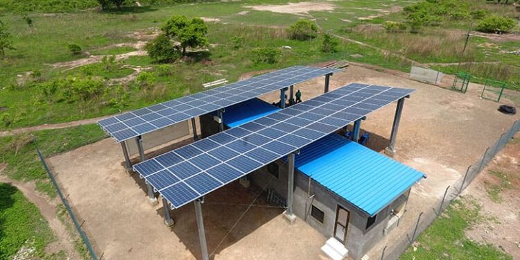 Solar mini-grid installation with rooftop panels supplying clean electricity to a rural African community
