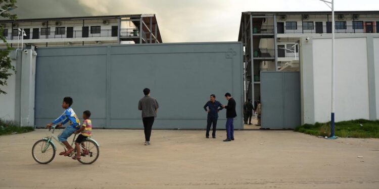 Entrance to a guarded compound in Cambodia linked to online scam operations investigated by authorities