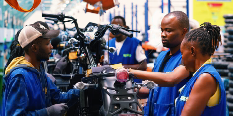 Technicians assembling electric motorcycles at a Spiro production facility supporting Africa’s growing electric mobility and battery-swapping network