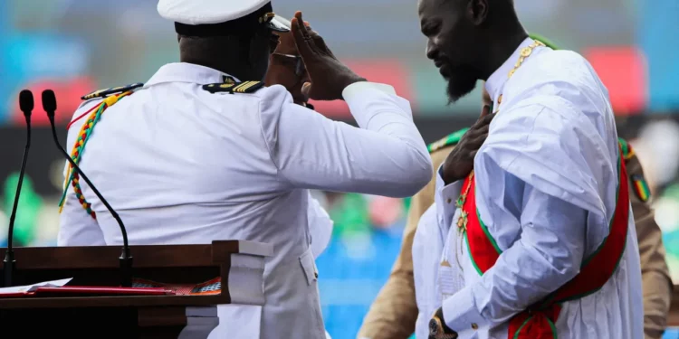 Guinea leader Mamady Doumbouya salutes during oath of office ceremony in Conakry