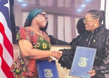Liberia’s Foreign Minister Sara Beysolow Nyanti shakes hands with Barbados High Commissioner Juliette Bynoe Sutherland during visa waiver agreement signing in Monrovia