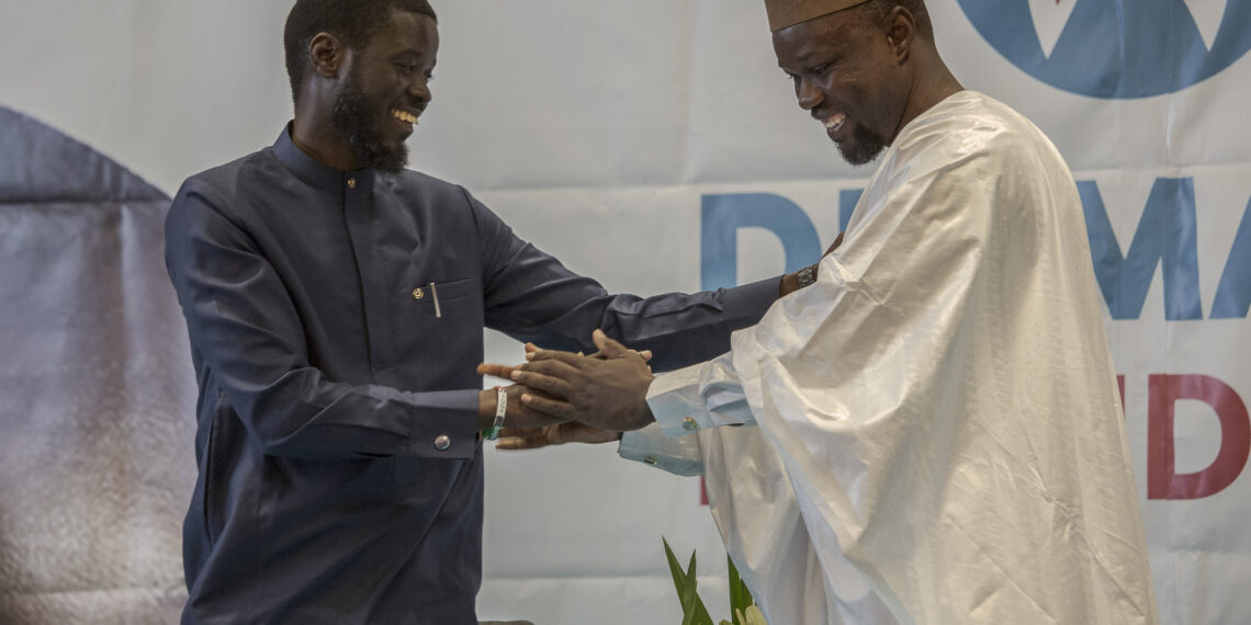 President Bassirou Diomaye Faye greets Prime Minister Ousmane Sonko during a political event in Dakar, Senegal, March 2024