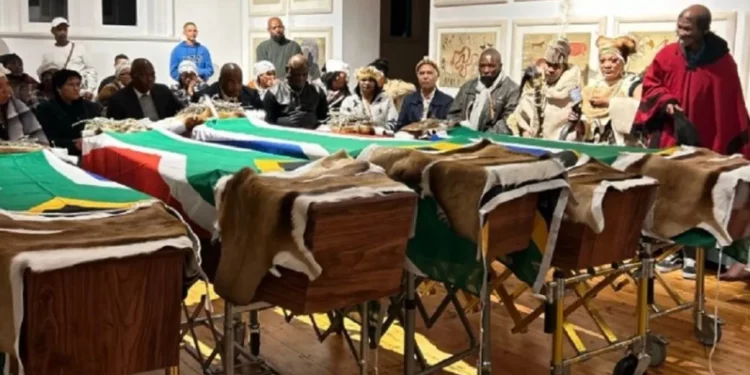 Coffins draped in South African flags at Khoi and San reburial ceremony in Steinkopf, attended by community leaders and officials