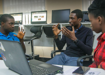 African technology entrepreneurs collaborating in a digital innovation hub