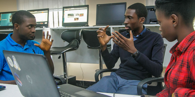 African technology entrepreneurs collaborating in a digital innovation hub