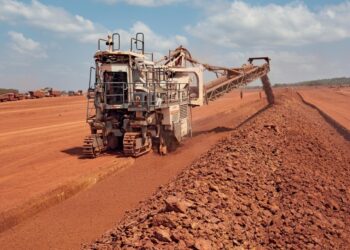 Bauxite mining operation in Africa with heavy machinery extracting red ore for alumina refining and aluminium production