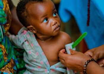 Infant undergoing malnutrition screening by community health worker in South Africa