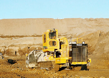 Large open-pit mining operation in Africa with heavy machinery extracting critical minerals
