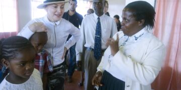 Madonna speaks with local staff and children during a visit to a Raising Malawi project in Malawi