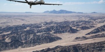 US surveillance drone flying over desert terrain during intelligence operations in the Sahel region of Mali.