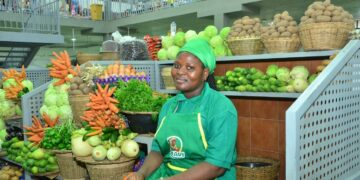Female market vendor selling fresh vegetables in a market in Benin