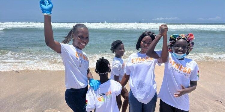 Young African youth smiling on beach in Ghana during community wellbeing activity