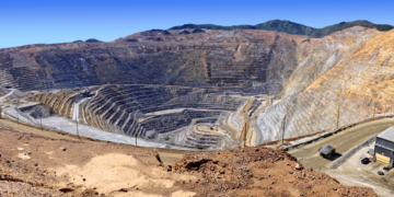 Open-pit copper mine in Zambia’s Copperbelt showing terraced excavation and heavy haul roads