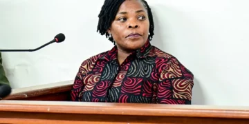 Agnes Nandutu speaks at a microphone during a public appearance in Uganda