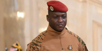 Captain Ibrahim Traoré in military uniform with red beret during an official indoor ceremony in Ouagadougou
