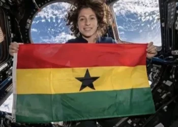 Christina Koch holds Ghana flag inside spacecraft during Artemis II mission beyond Earth orbit