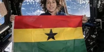 Christina Koch holds Ghana flag inside spacecraft during Artemis II mission beyond Earth orbit