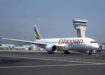 Ethiopian Airlines Boeing 787 Dreamliner taxiing on runway at Addis Ababa Bole International Airport with control tower in background
