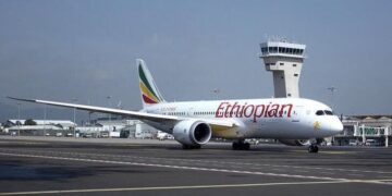 Ethiopian Airlines Boeing 787 Dreamliner taxiing on runway at Addis Ababa Bole International Airport with control tower in background