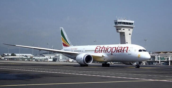 Ethiopian Airlines Boeing 787 Dreamliner taxiing on runway at Addis Ababa Bole International Airport with control tower in background