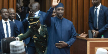 Senegal Prime Minister Ousmane Sonko raises his hand in parliament during a legislative session in Dakar