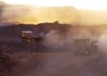Heavy-duty trucks operate in an open-pit gold mine in Africa as governments tighten control over mining licences