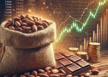 Sack of cocoa beans with chocolate bars and rising market charts in the background, illustrating cocoa price movements