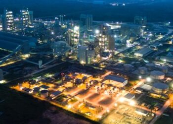 Dangote Refinery complex in Lagos showing large-scale oil refining infrastructure and storage tanks at night