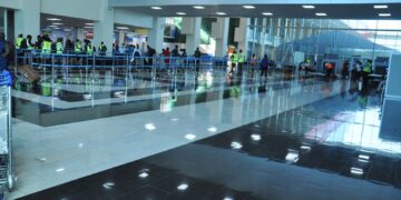 Passengers queue at Entebbe International Airport arrivals hall in Uganda, where US deportees were received under a new migration agreement