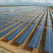 Large-scale solar farm in Africa showing rows of photovoltaic panels, illustrating renewable energy expansion and electrification efforts