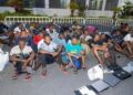 Rescued trafficking victims, including children, sit under supervision during a Ghana anti-trafficking operation in Accra