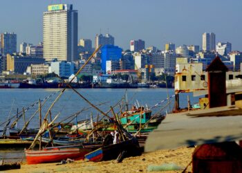 Maputo skyline and harbour in Mozambique with fishing boats and city buildings, reflecting the country’s economy amid IMF debt repayment
