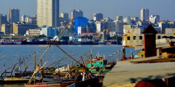Maputo skyline and harbour in Mozambique with fishing boats and city buildings, reflecting the country’s economy amid IMF debt repayment