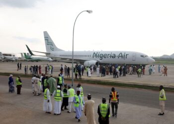 Nigeria Air aircraft on runway with passengers and officials gathered amid aviation fuel crisis