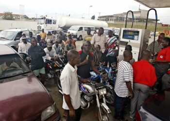 Motorists queue at a petrol station in Nigeria as fuel prices surge, reflecting rising living costs amid oil price shocks