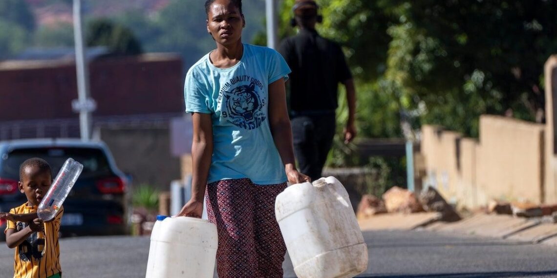 South Africa water shortage residents carrying containers urban infrastructure crisis