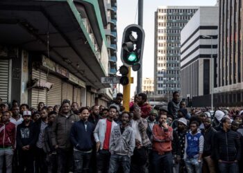 African migrants stand in Johannesburg’s central business district during tensions over immigration in South Africa