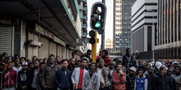 African migrants stand in Johannesburg’s central business district during tensions over immigration in South Africa