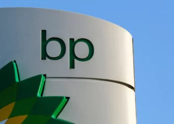 BP logo displayed on a fuel station sign against a clear blue sky.